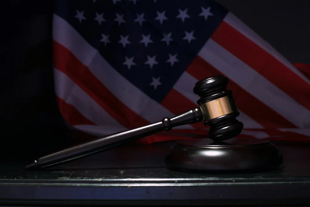 Digital still shot of a court gavel in front of an American flag