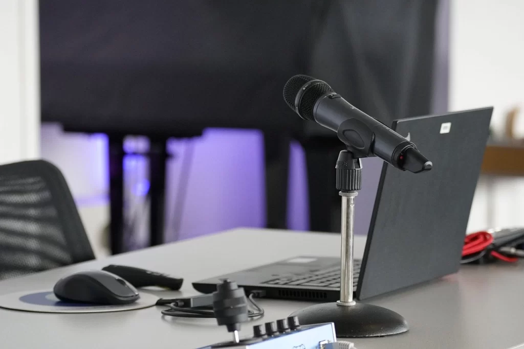 Close up of a microphone beside a laptop